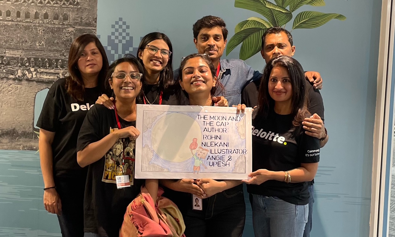 Deloitte team holding The Moon and the Cap storybook at NGO literacy session